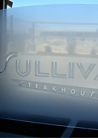 Partition with Frosted Glass Logos Sullivans Steakhouse (similar look) Design by Sans Soucie