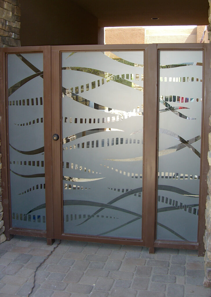 Modern entry gate glass inserts with flowing etched patterns and frosted privacy glass for contemporary homes.