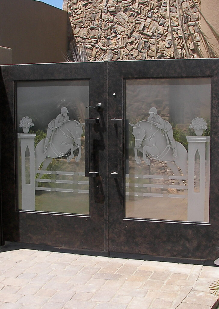 Etched glass gate showcasing horse jumping artwork on decorative frosted glass inserts for luxury residential entryways.