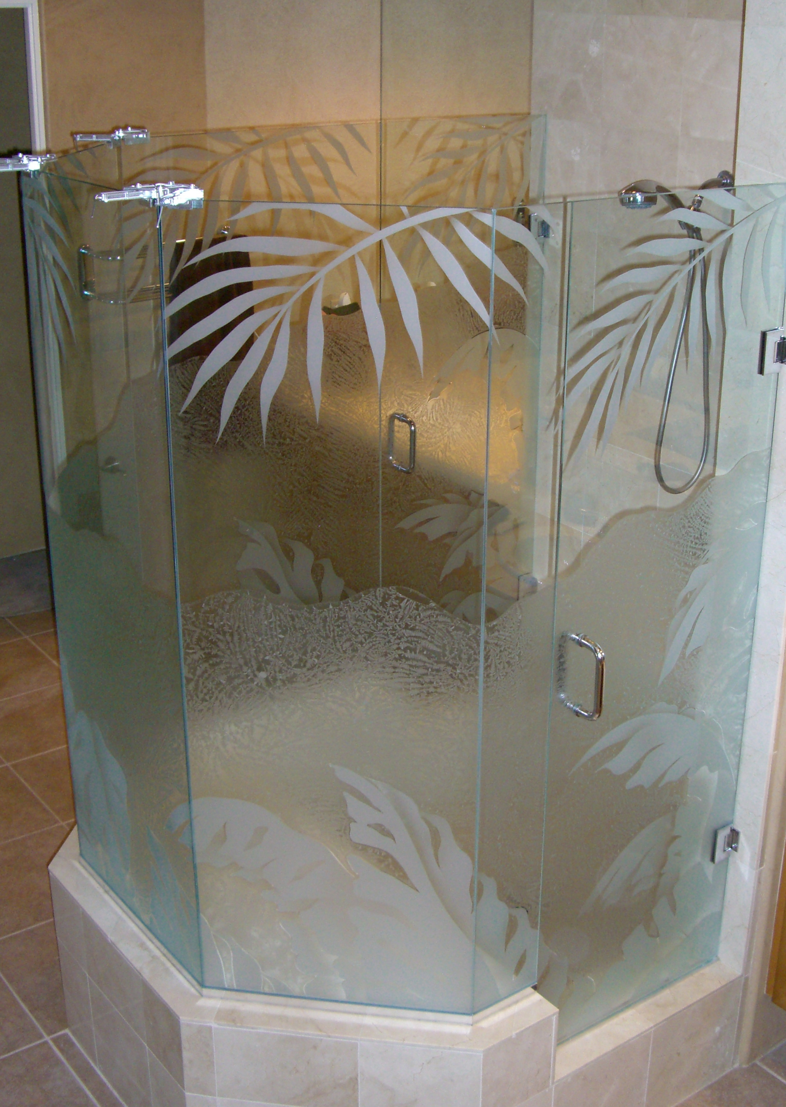 Custom frameless shower enclosure with frosted glass tropical fern leaf design creating privacy in a modern bathroom