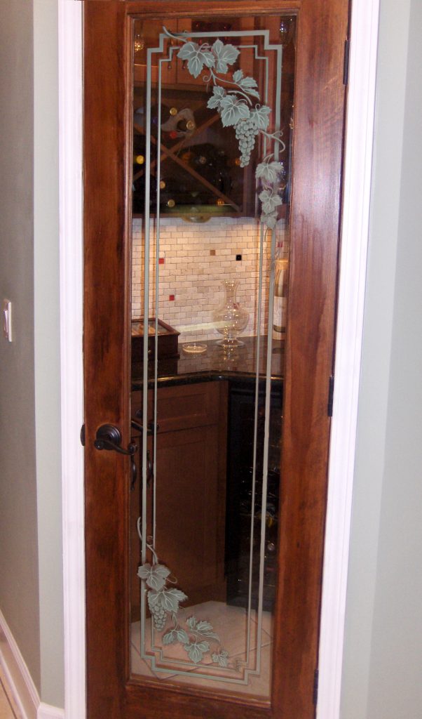 Clear glass pantry door with etched  vineyard grapes