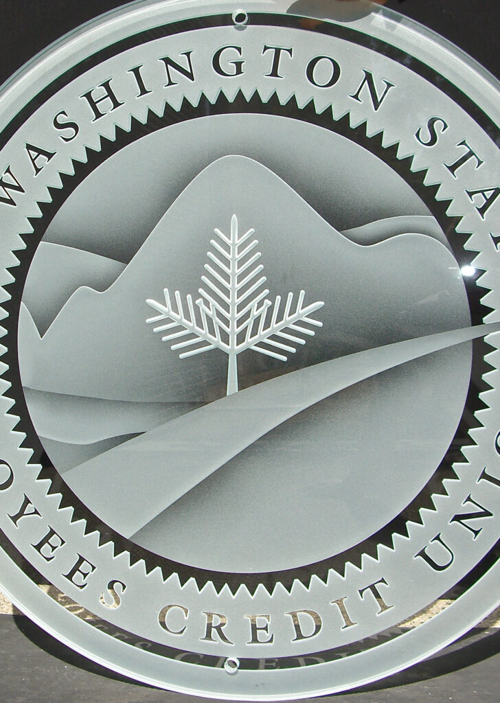 Custom etched and carved glass seal sign with polished edges, displaying intricate logo detail and professional business branding