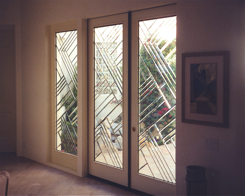 Front doors with glass featuring clear and frosted geometric beveled glass patterns for a modern entryway.