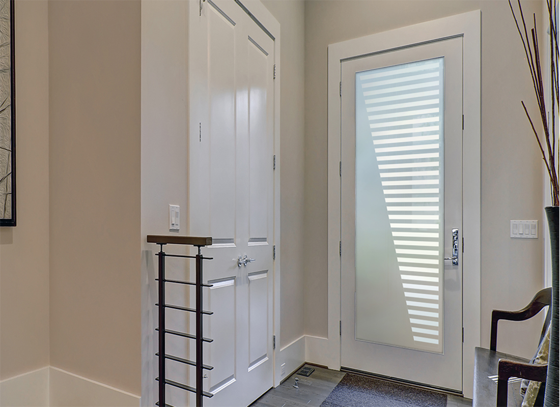 Frosted glass panel on fiberglass entry door providing privacy while brightening the foyer