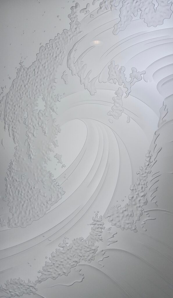 Close-up of Curl ocean wave design on 3D carved frosted glass with high privacy and sculpted sandblasted wave texture.