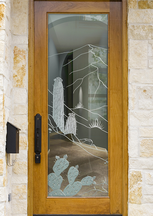 Frosted glass front door with etched cactus and desert mountains