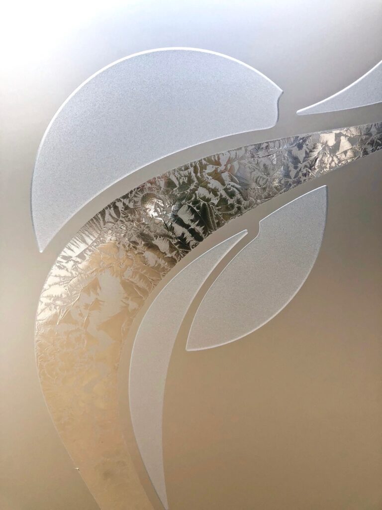 Close-up of Ribbon Reflection Moons design on 3D enhanced frosted glass with gluechip texture and privacy.