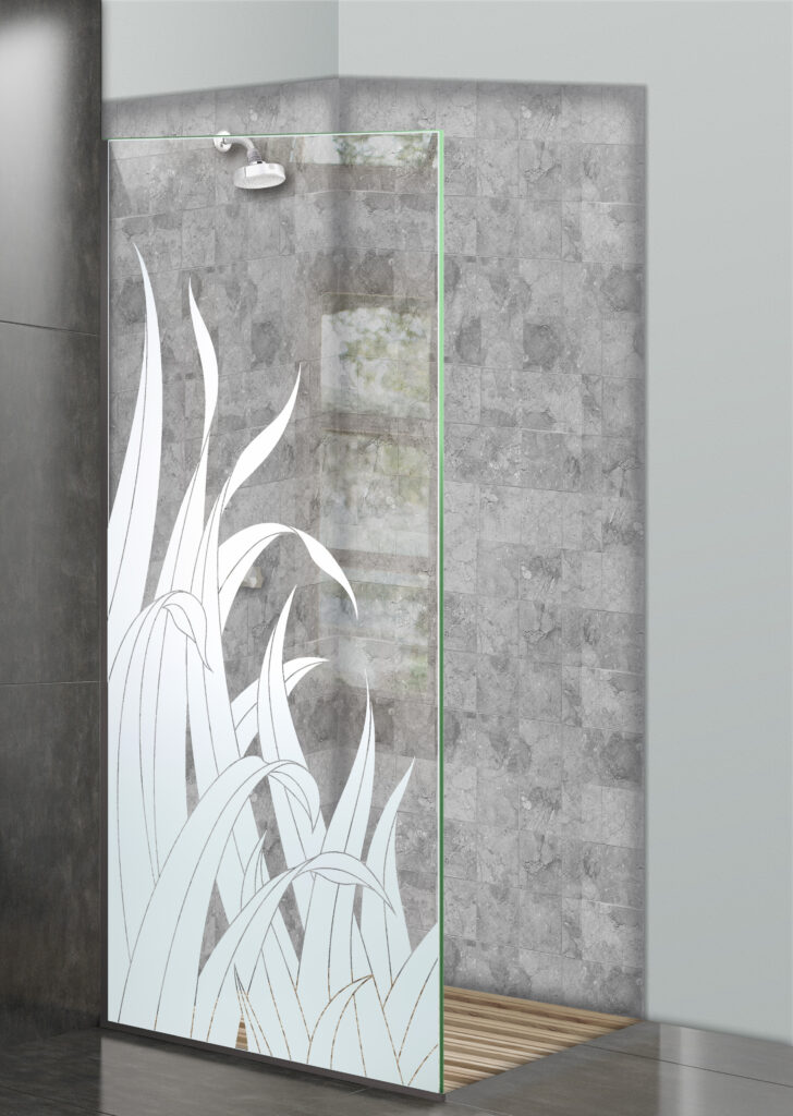Glass shower divider with frosted reeds and tall grass design in a gray tile walk-in shower.