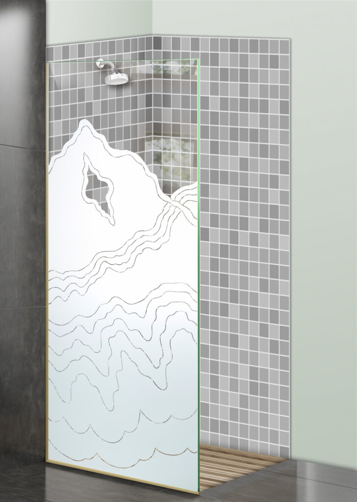 Glass shower divider with frosted rugged mountain design in a gray mosaic tile shower.
