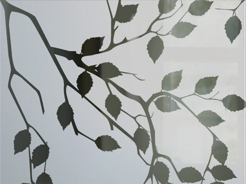 Close-up of etched glass leaf branch design highlighting fine detail and frosted glass texture for privacy and light diffusion