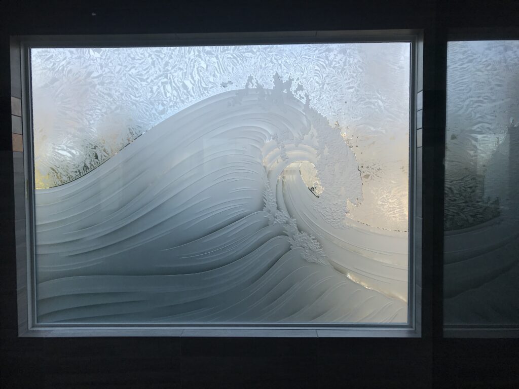 Small bathroom window with artistic etched glass