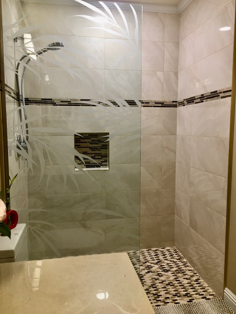 Shower panel with etched grass design in walk-in shower