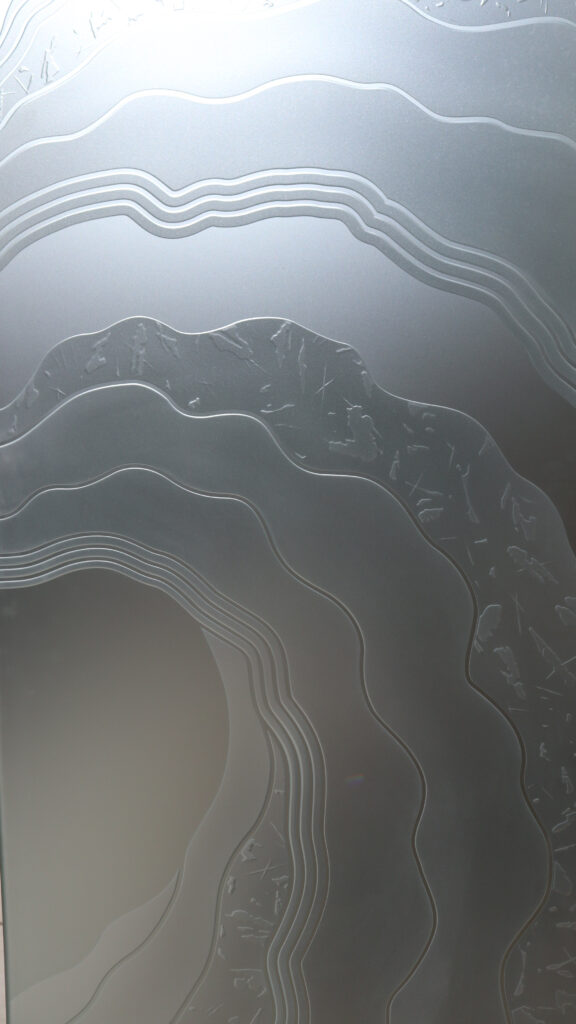 Close-up of private frosted glass with layered MetaCurl pattern and soft flowing textures