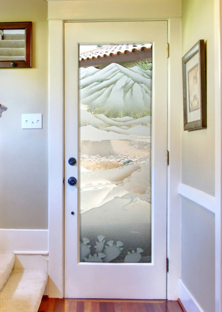 Decorative glass door with layered desert mountains and cactus design