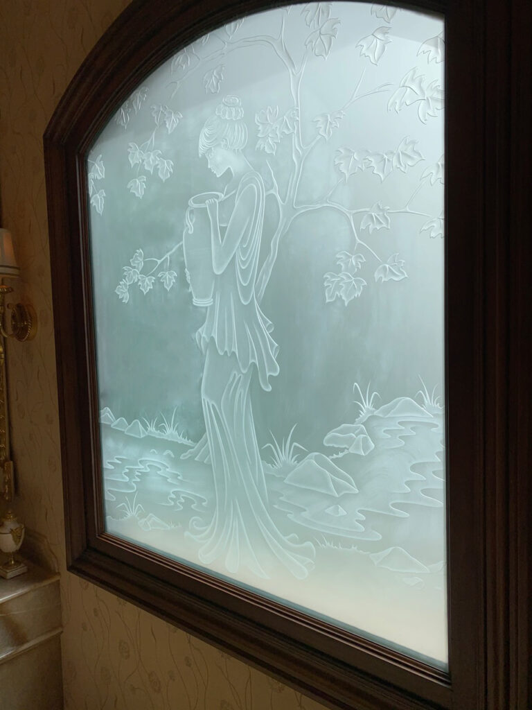 Privacy-friendly frosted glass window for small bathrooms, featuring handcrafted sandblast etching.