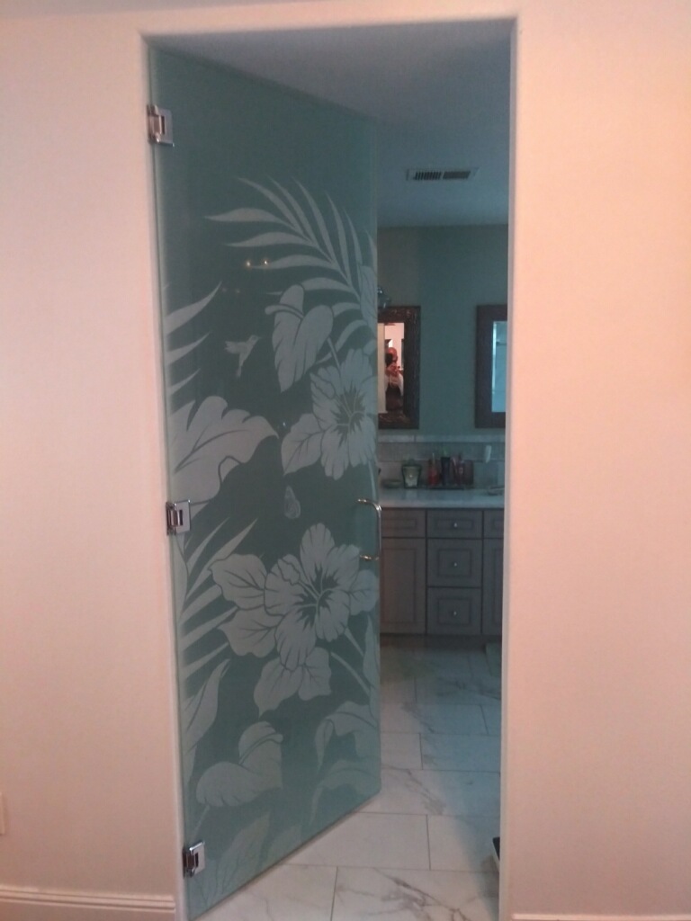 Frameless frosted bathroom door with   full privacy and stunning one dimensional etched floral design