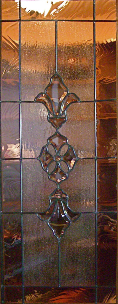 Close-up of decorative leaded beveled glass design with textured glass background and faceted bevel details