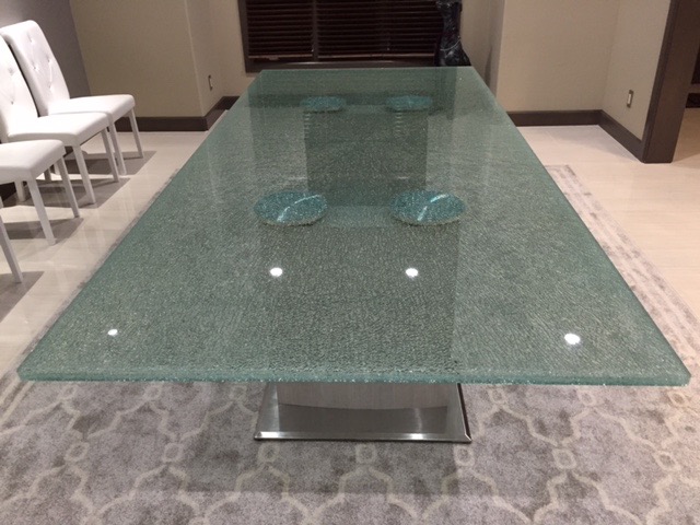 Frosted glass dining table showcasing handcrafted custom glass artistry.