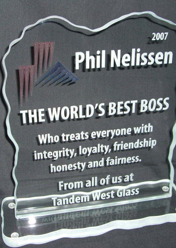 Custom etched glass plaque award with engraved text and logo, featuring polished edges and a sleek, professional presentation