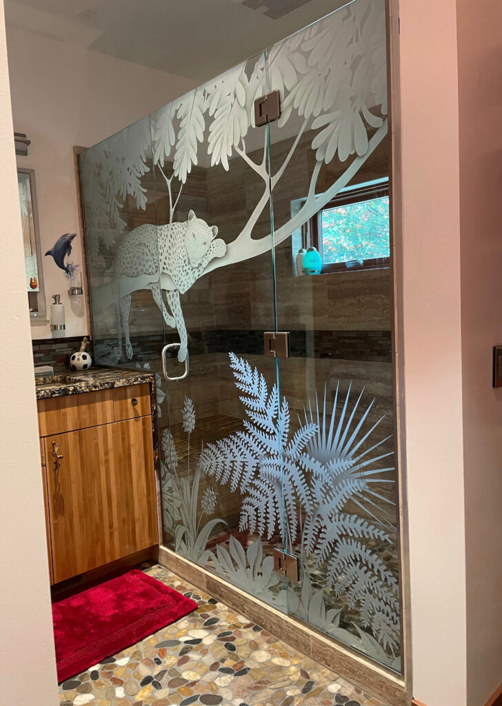 Frameless glass shower enclosure with stunning wildlife design