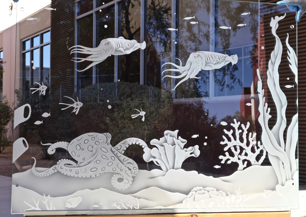 Decorative interior glass partition with carved octopus and marine life etched glass artwork