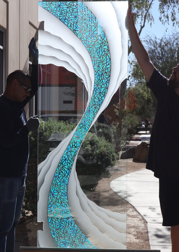 A mesmerizing custom glass design, where dynamic curves and vibrant blue patterns create a captivating visual flow.