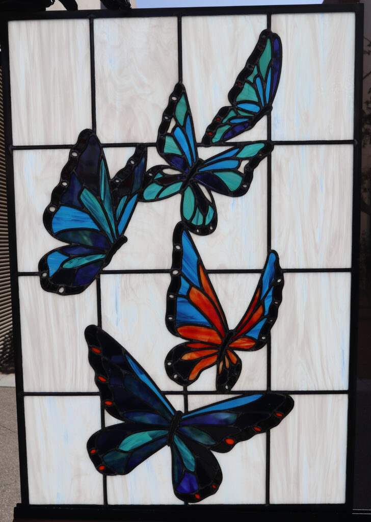 A stained glass with a butterfly design