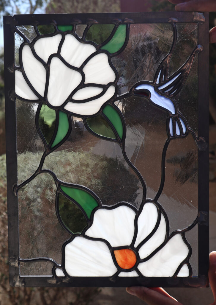 Stained glass featuring a hummingbird  and magnolias