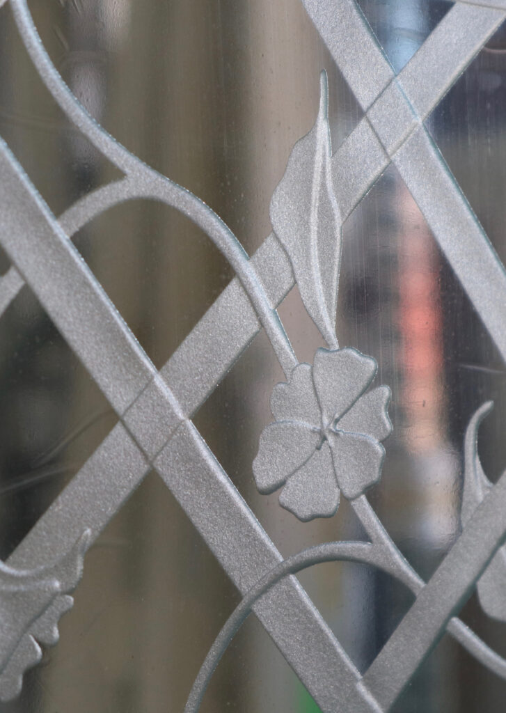 A close-up detailed look of a carved glass table top.