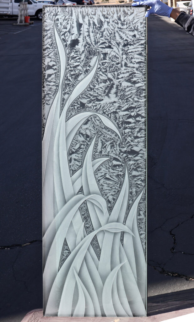 Glass panel with reeds design and textured background for a contemporary interior door.