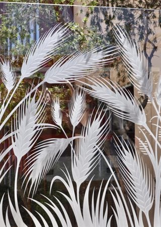 Window showcasing a Frosted Glass Foliage Design with Sandblast Etched Glass Art by Sans Soucie Wheat  Design