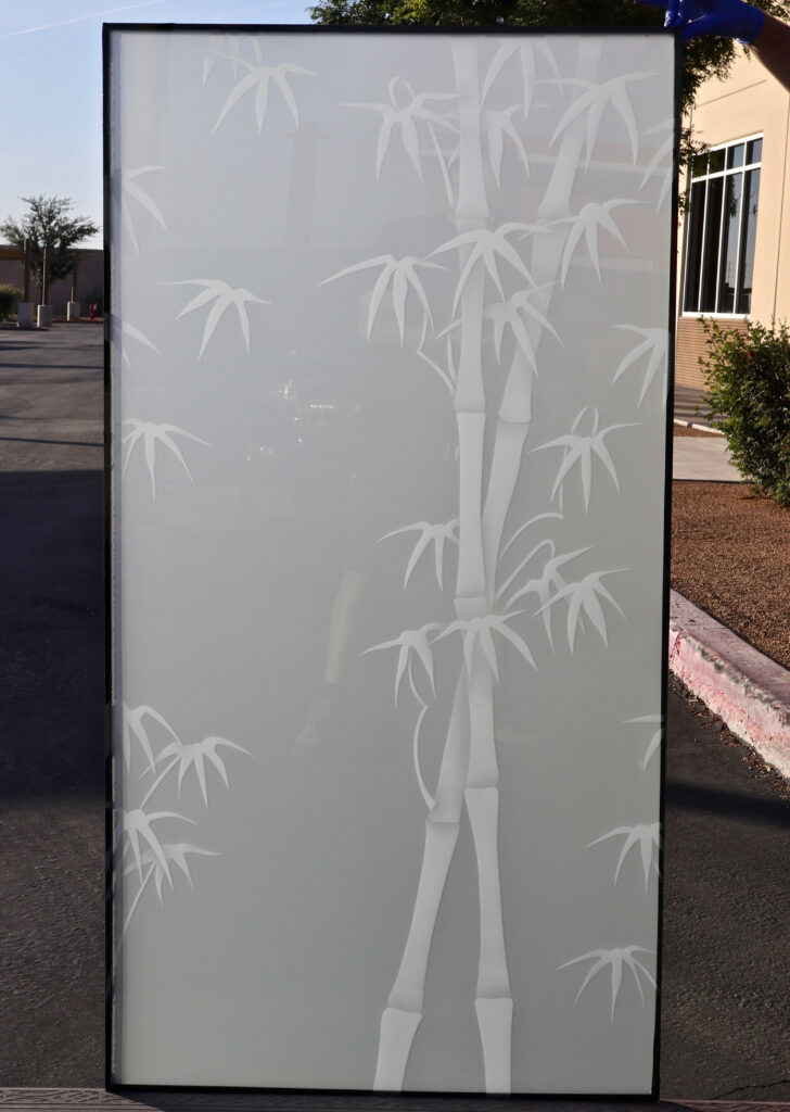 Frosted bamboo glass partition panel with elegant bamboo stalks creating privacy in a modern interior