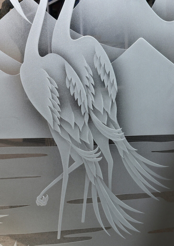 The carved glass design: Cranes & Cattails up close