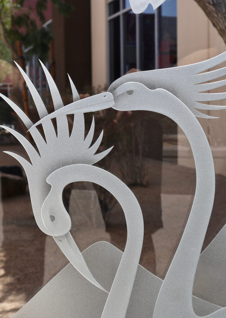 Seen up close, the carved glass design: Cranes & Cattails