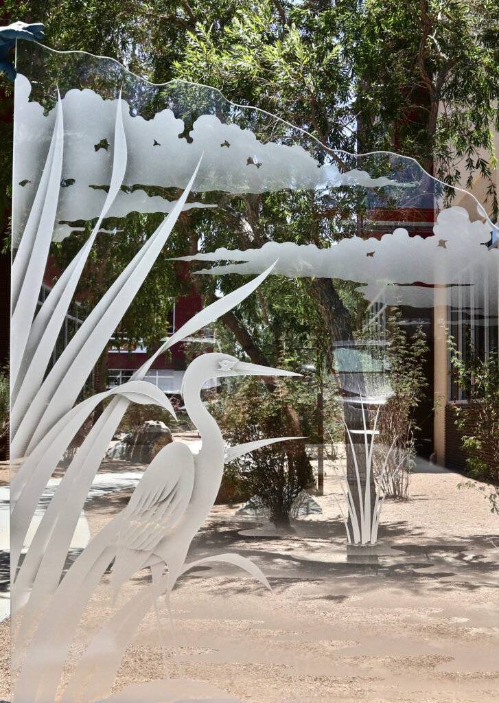 Decorative glass partition panel with a 3D carved egret standing in reeds beside a tranquil wetland scene, showcasing detailed frosted glass artistry.