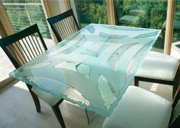 custom glass dining table with frosted carved glass geometric design irregular edge
