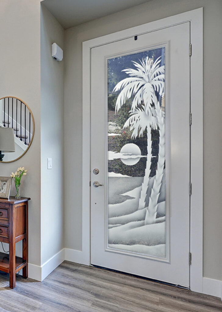 Etched glass front door with palm trees and sunset beach scene