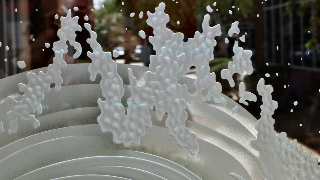 Close-up of a custom ocean wave glass partition panel showcasing intricate 3D carved sea foam textures and dimensional frosted glass craftsmanship.