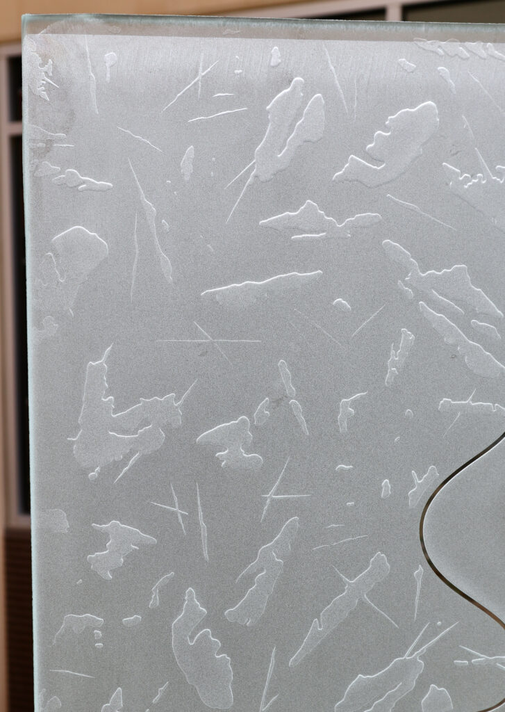 Detailed view of Metamorphosis glass design, a frosted carved glass texture, ideal for a black front door that allows light in without sacrificing privacy.