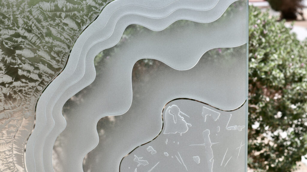 Close-up of dimensional etched glass design Metamorphosis, with flowing abstract lines, designed for a black front door with glass panels that offers modern style and subtle privacy.