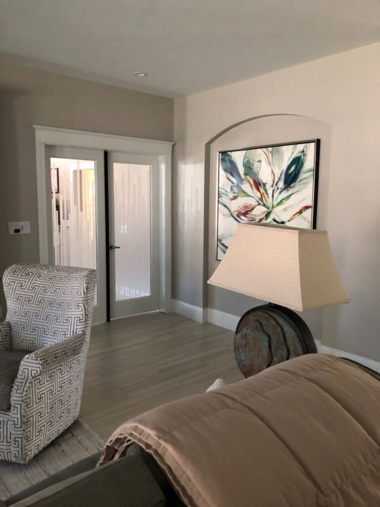 Pair frosted glass interior doors with vertical modern design separating living spaces in contemporary home