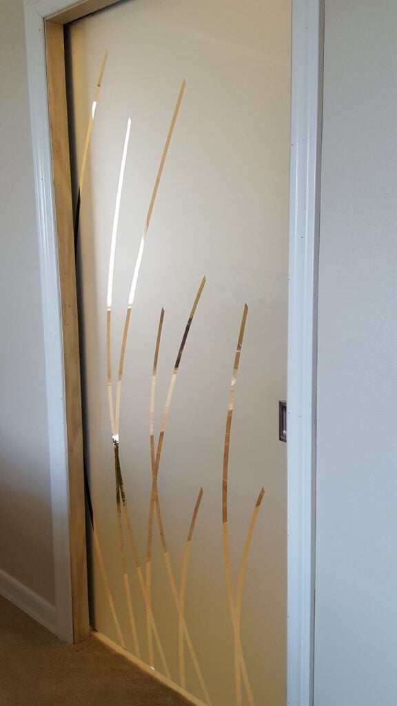 All glass pocket pantry door with Sleek Arcs design