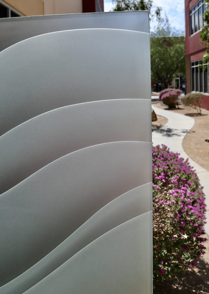 Close-up of 3D carved and shaded frosted glass with high privacy and layered dreamy wave design