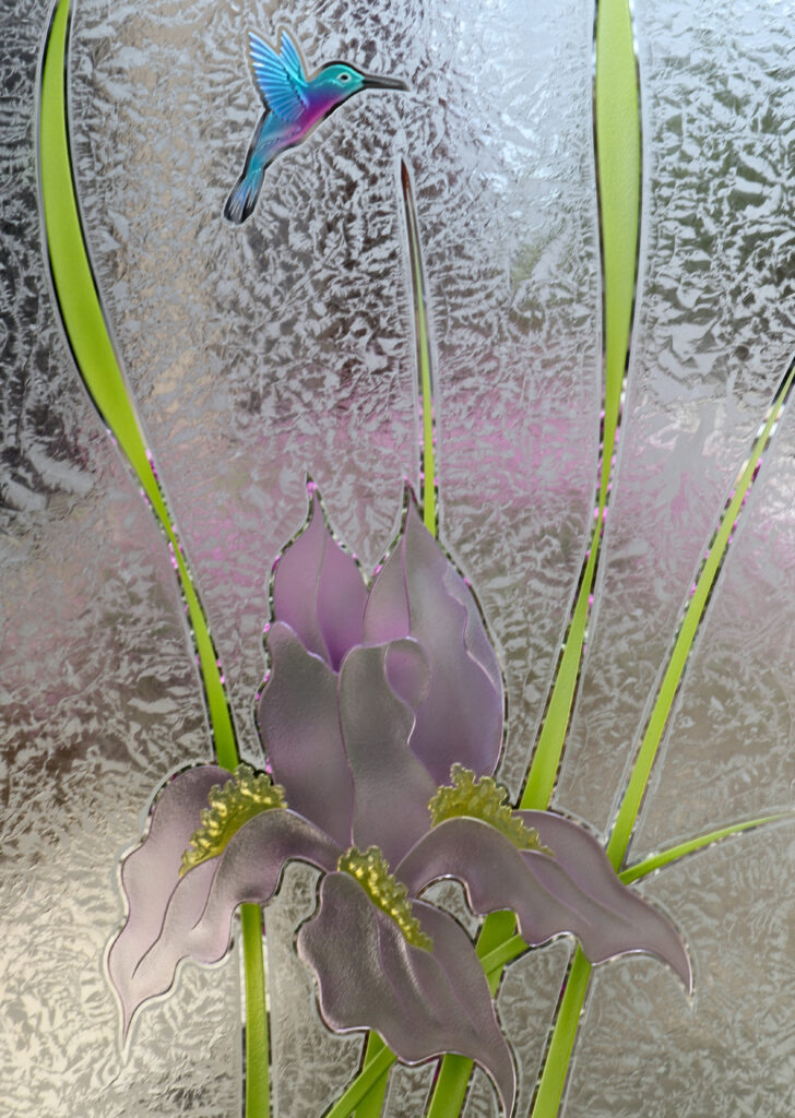 Tropical frosted glass door with carved iris flowers and hummingbird, hand airbrushed with soft purple and green tones over textured gluechip glass