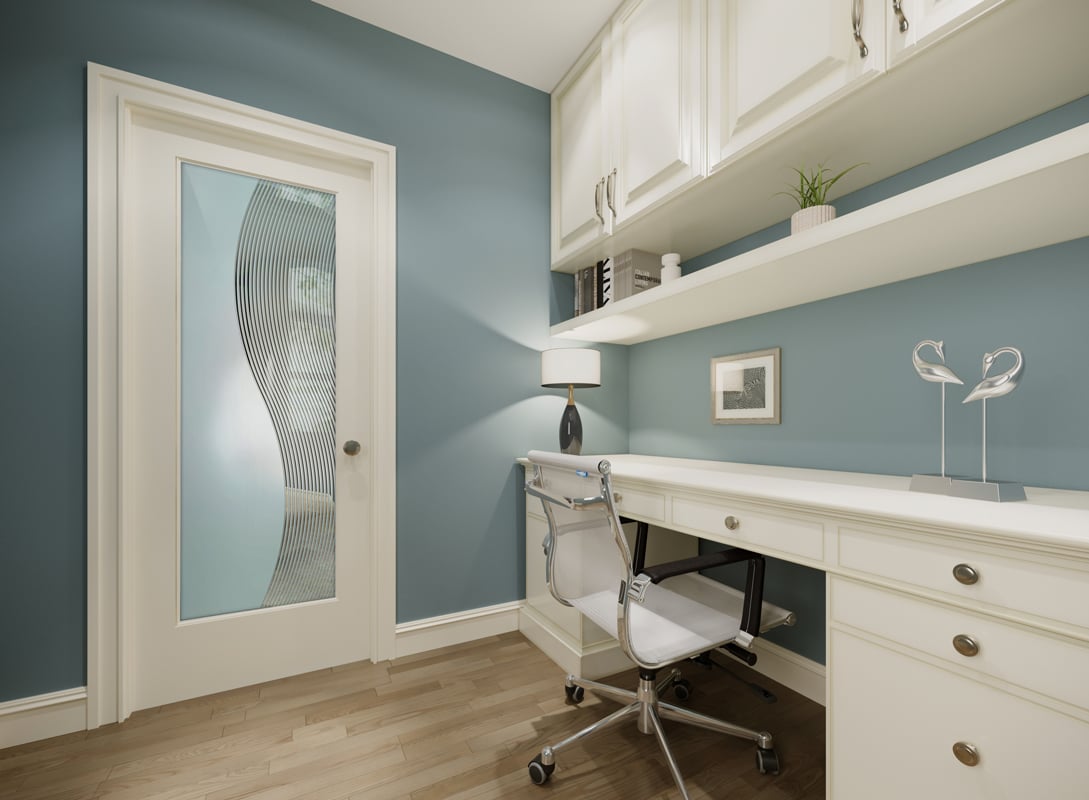 Modern home office with a white desk, built-in cabinets, and a frosted glass interior door featuring an abstract curved stripe design that provides privacy while allowing light.