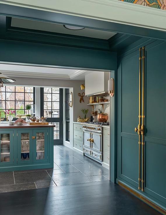 peacock blue floor to ceiling pantry cabinet doors with gold hardware 