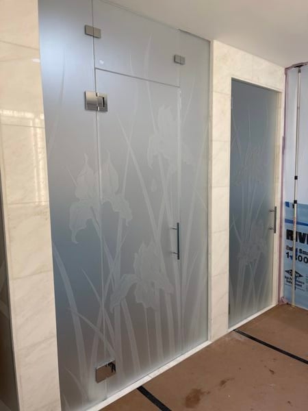 Shower Enclosure featuring a Frosted Glass Floral Design Sandblast Etched Glass Iris Hummingbird Design by Sans Soucie