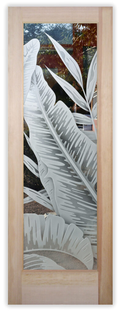 Frosted and carved glass interior door featuring oversized tropical leaves, adding texture and privacy in a coastal and tropical-inspired design