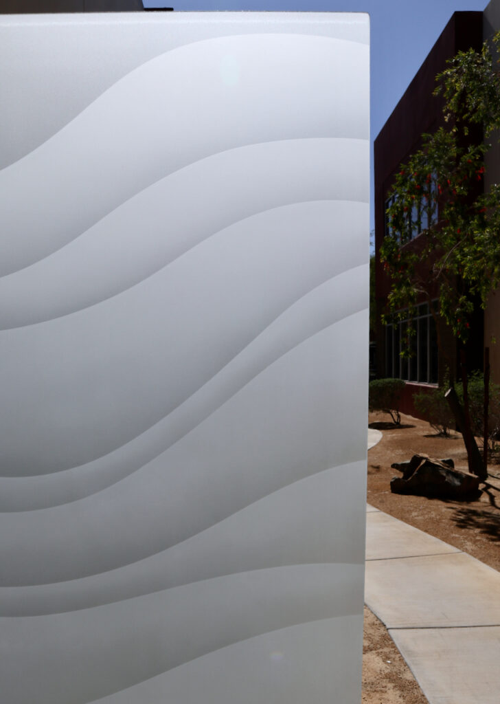 Close-up of 2D etched glass with privacy and simple curved wave lines