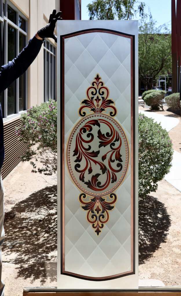 Ornate royal filigree glass door design for modern homes, featuring carved frosted glass, painted accents, and decorative privacy.